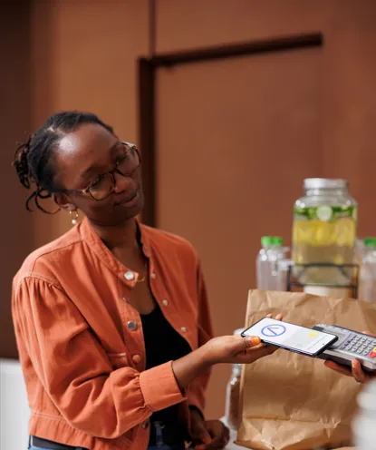 A cashier ringing up a sale on a Revoluno point-of-sale terminal